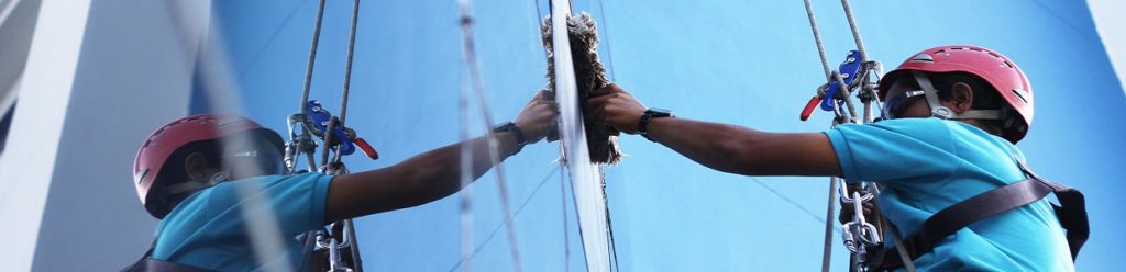 50255651 - worker cleaning windows service on high rise building